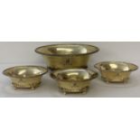 A large 4 footed silver gilt oval wide rimmed bowl with 3 matching smaller bowls.
