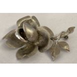 A Silver brooch in the shape of a rose with brushed effect detail to petals and leaves.