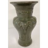A Chinese celadon glazed wide rimmed vase with rams head detail.