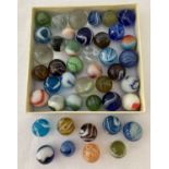 A bag of old coloured and clear glass marbles.