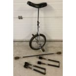A chrome framed unicycle together with a collection of fire juggling torches/batons.