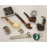 A small collection of smoking related items. To include lighters, pipes and a cigar cutter.