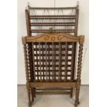 A vintage dark wood cot with barley twist posts and bobbin style spindles.
