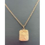 A vintage rose gold square shaped locket with floral engraving to front.
