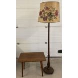 A vintage wooden standard lamp with large floral design paper shade.
