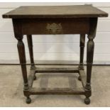 A 17th century antique dark oak side table with single drawer & turned legs with stretcher supports.