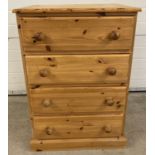 A modern solid wood pine 4 drawer chest with bun handles.