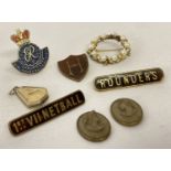 A small collection of vintage jewellery and enamel badges.