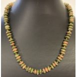 A 16" unakite oval shape beaded necklace with gold tone magnetic clasp.