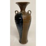 A Chinese stoneware 2 handled vase with brown and blue drip glaze.