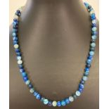 An 18" costume jewellery necklace made from polished blue banded and dyed agate beads.
