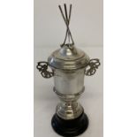 A vintage silver lidded trophy cup with 3 golf club finial to top and pierced work lion handles.