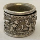 A Chinese white metal Archers ring with central rotating panel decorated with figural detail.