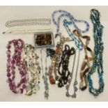 A quantity of vintage shell, natural stone and glass bead necklaces.