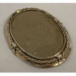 A large sterling silver empty portrait brooch/pendant with rope chain detail to edge.
