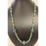 A 22" green aventurine and faceted agate beaded necklace with silver tone hook clasp.