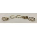 5 silver and white metal stone set band style rings in varying sizes and designs.