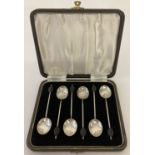 A cased set of silver coffee spoons with black coffee bean detail to handles.
