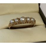 A vintage 9ct gold and pearl half eternity style dress ring with scroll detail to mount & shoulders.