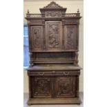 An early 20th century carved oak French dresser with 5 cupboards and 2 drawers.