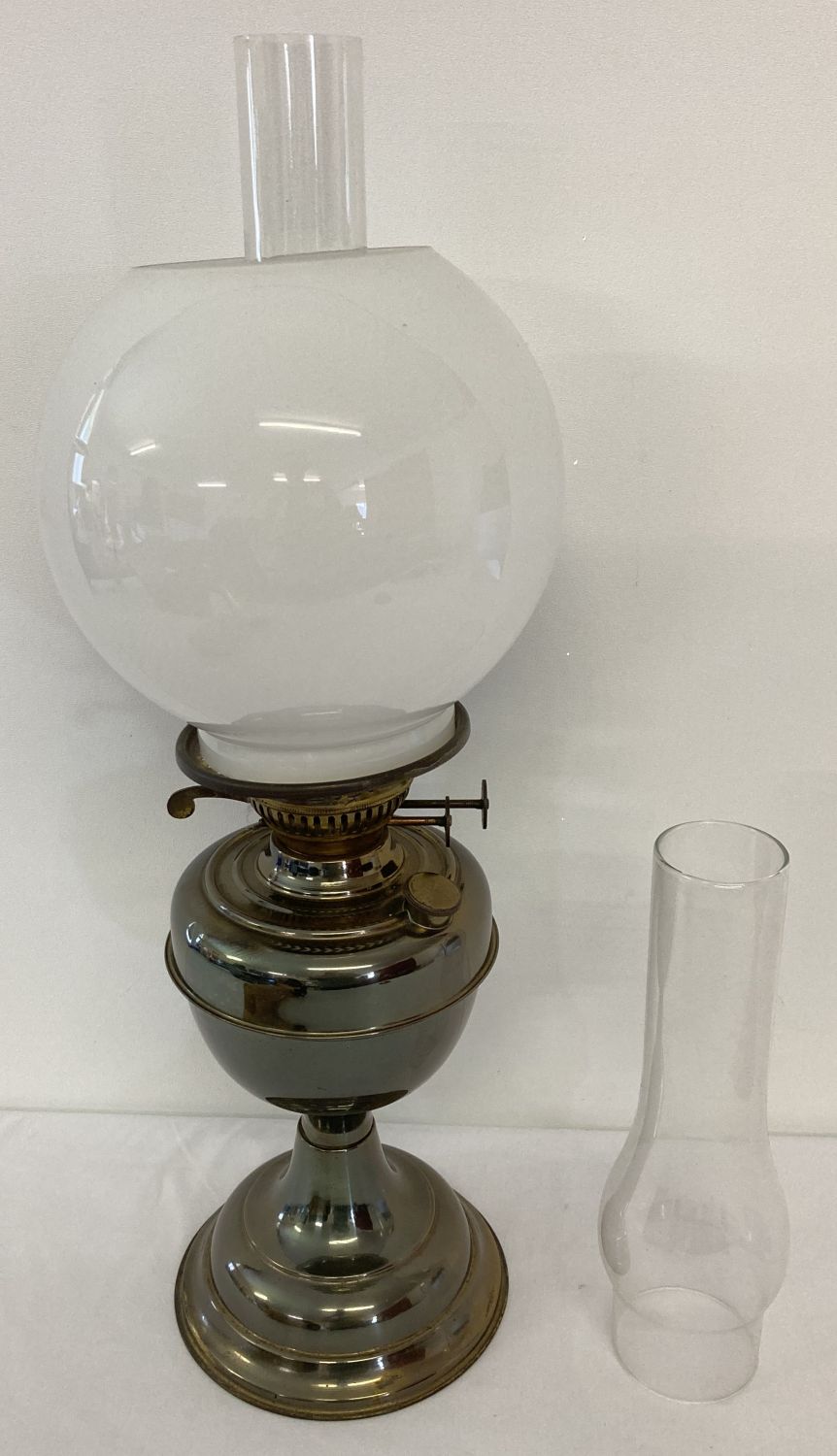 A vintage Duplex twin wick oil lamp, complete with chimney, white glass globe shade & spare chimney.