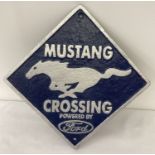 A square shaped painted cast iron wall hanging plaque for Mustang, powered by Ford.