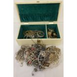 A vintage cream jewellery box containing a quantity of modern and vintage jewellery.