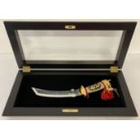 An oriental style ornamental knife with dragons head shaped pommel & curved blade.