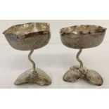 A pair of vintage white metal ornately decorated stemmed goblets, possibly Persian silver.