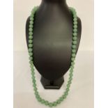 A 32" Chinese apple jade beaded necklace, knotted between each bead.