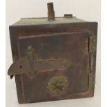 A vintage copper steriliser with opening front door.