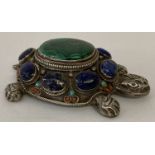 A decorative silver stone set trinket/pill box in the shape of a tortoise.