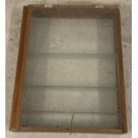 A hand made vintage wooden framed display cabinet with glass back and shelves.