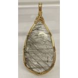 A Krasivka jewellery astrophyllite in quartz pendant with 14ct gold filled wire by Sheila Harrison.