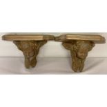 2 vintage chalk wall hanging shelves, painted gold and with cherub detail.