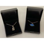 2 boxed silver pendant necklaces.