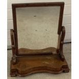 A Victorian mahogany table top swing mirror with shaped base and supports, frame a/f.