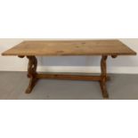 A large pine refectory style table with trefoil cut out detail to ends.