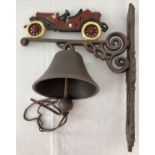 A cast metal wall hanging garden bell with classic veteran car painted detail.