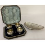 A vintage cased set of 4 silver plated, 3 footed salts with floral decoration.