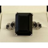 A silver modern design statement dress ring set with black spinel.