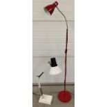 A heavy based angle poise style desk lamp together with a modern red metal standard lamp.