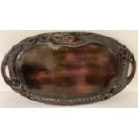 An oriental wooden oval tray with carved dragon to edges and black lacquer detail to back.