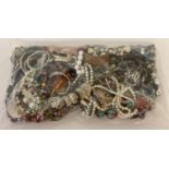 A sealed bag of mixed modern costume jewellery to include bangles, necklaces and bracelets.