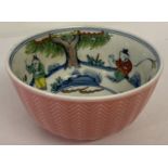 A Chinese ceramic tea bowl with hand painted figural detail to inner bowl & pink glazed outer bowl.