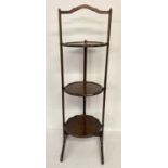 An Edwardian mahogany 3 tier folding cake stand with scalloped detail to platform edges.