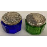 2 octagonal shaped, coloured glass trinket pots with sterling silver lids of Art Nouveau design.