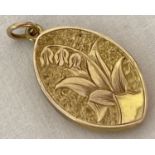 A Victorian gold (front & back) marquise shaped locket with lily of the valley decoration.