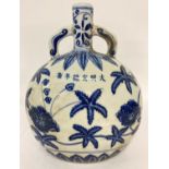 A Chinese hand painted blue and white ceramic moon vase with floral design.