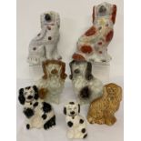 A collection of 7 Staffordshire and Staffordshire style ceramic dogs.